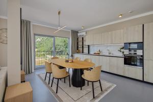 a kitchen and dining room with a table and chairs at Sea Breeze Residence in Kotor +14 photos