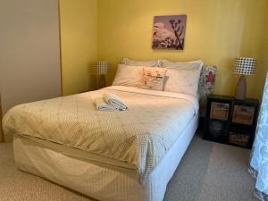 a bedroom with a bed with two slippers on it at Amazing Perfect Family Home - GC Beach location in Gold Coast +23 photos