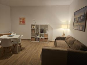 a living room with a table and a couch and a dining room at Vanvitelli's Guest House -Affittacamere in Airola
