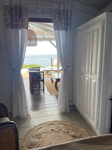 a room with a door with a view of the ocean at Villa Pelican Lodge in Deshaies