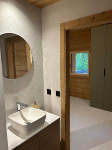 a bathroom with a white sink and a window at 35 m2 duplex in a new 2025 chalet in Saint-Gervais-les-Bains