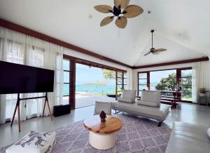 a living room with a tv and a couch and a table at Luxurious Bali-style 5-bedroom sea view pool villa at Bophut Beach, Koh Samui, close to Chaweng Beach in Amphoe Koh Samui