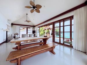 a living room with a wooden bench and windows at Luxurious Bali-style 5-bedroom sea view pool villa at Bophut Beach, Koh Samui, close to Chaweng Beach in Amphoe Koh Samui
