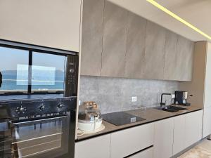 a kitchen with a sink and a stove top oven at La Terrazza Azzurra in Vlorë