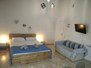 a bedroom with a bed and a couch at Patra Studio B4 in Patra
