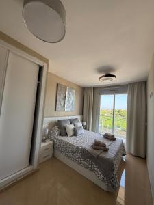 a bedroom with a bed and a large window at MAGIC WORLD Vacaciones in Castellón de la Plana +16 photos