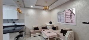 a living room with a couch and a table at Appartement à louer Al Hoceima vue mer in Al Hoceïma