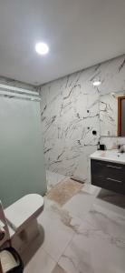 a bathroom with a toilet and a sink at Appartement à louer Al Hoceima vue mer in Al Hoceïma