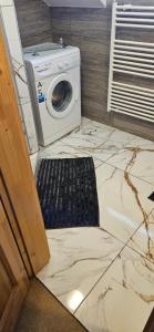 a washer and dryer sitting on a marble floor at Apartmán Siuzen in Brezno