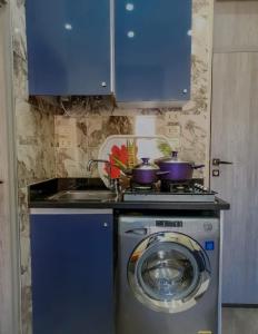 a kitchen with a stove and a washing machine at زافيرو محطه الرمل للعائلات فقط - families only in Alexandria +44 photos