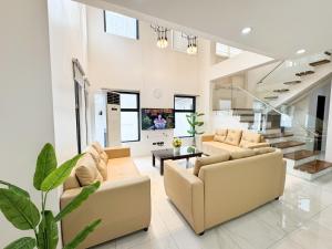 a living room with two couches and a table at Halika Villa & Capitolo events place near BGC in Manila