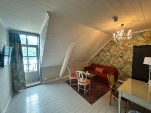 a living room with a couch and a table at Hofslund Fjord Hotel in Sogndal