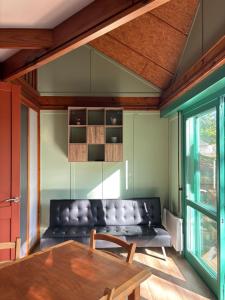 a living room with a couch and a table at Camp Les Deux in Jouillat