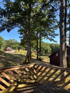 a wooden fence in front of a field with trees at Camp Les Deux in Jouillat