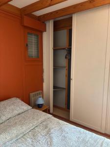 a bedroom with a bed and an open closet at Camp Les Deux in Jouillat