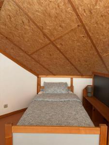 a bedroom with a bed and a flat screen tv at Camp Les Deux in Jouillat +10 photos