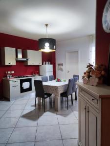 a kitchen and dining room with a table and chairs at Spacious 3Bedroom Apartment in Nardò, Apulia, Balcony, AC, Wi-Fi in Nardò