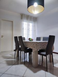 a dining room with a table and chairs at Spacious 3Bedroom Apartment in Nardò, Apulia, Balcony, AC, Wi-Fi in Nardò +12 photos