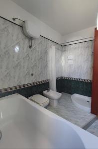 a bathroom with a tub and a toilet and a sink at Spacious 3Bedroom Apartment in Nardò, Apulia, Balcony, AC, Wi-Fi in Nardò