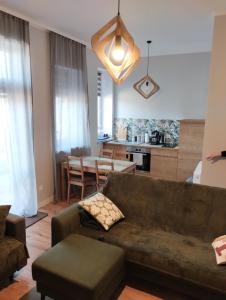 a living room with a couch and a table at Apartament 103 in Lądek-Zdrój
