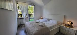 a bedroom with a bed and a large window at 300 mil in Szklarska Poręba +38 photos