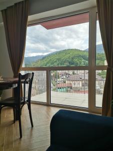 a room with a table and a window with a view at Perla Sinaia in Sinaia