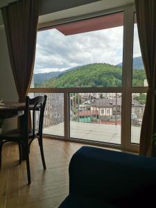 a room with a window with a view of a city at Perla Sinaia in Sinaia