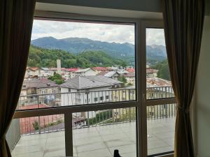a window with a view of a city at Perla Sinaia in Sinaia +52 photos