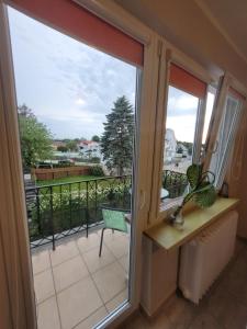 a sliding glass door with a view of a balcony at Pokoje gościnne Ustronie Morskie - 260m do plaży in Ustronie Morskie +14 photos