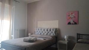 a bedroom with a bed with a white head board at B&B home vintage in Marconia