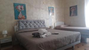 a bedroom with a bed with a stuffed elephant on it at B&B home vintage in Marconia