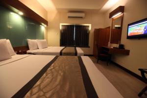 A bed or beds in a room at Microtel by Wyndham UP Technohub