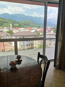 a table with a bowl of fruit on top of a balcony at Perla Sinaia in Sinaia