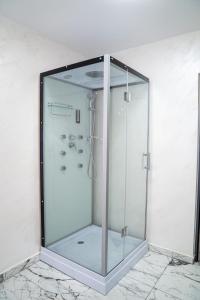 a shower with a glass enclosure in a bathroom at PentGarden penthouse jacuzzi in Târgu Jiu +8 photos