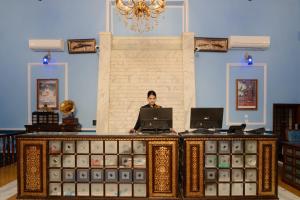 a woman standing behind a desk with a laptop at The Kurki Heritage in Jaipur +61 photos