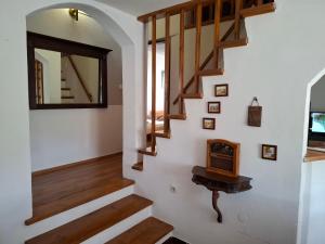 a staircase with a mirror and a wooden stair case at Holiday house Bore in Babino Polje