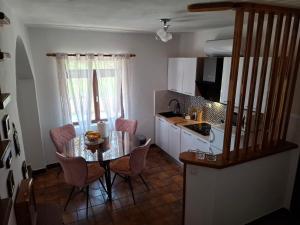 a small kitchen with a table and chairs in a room at Holiday house Bore in Babino Polje