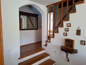 a hallway with wooden stairs and a mirror at Holiday house Bore in Babino Polje