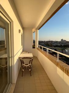 a balcony with a table and a view of the city at Apartamento de Férias in São Félix da Marinha