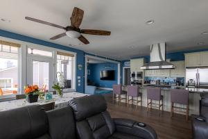 a living room with a couch and a ceiling fan at Blue Marlin in Hampton +61 photos