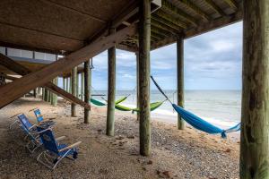 two chairs and a hammock on a beach at Blue Marlin in Hampton