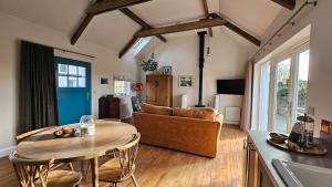 a living room with a table and a couch at The Byre At Springbank in Kilrea