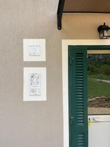 a building with a green door and a window at Nina s Casa di Langa in Rocca Ciglie +25 photos
