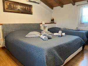 two beds in a bedroom with blue sheets at Rooms Barbieri Rovinj in Rovinj +13 photos