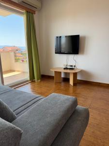 a living room with a couch and a flat screen tv at Vespera Apartments in Bol