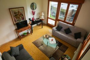 a living room with a couch and a table at Panoramic Lake View Apartment in Nago-Torbole