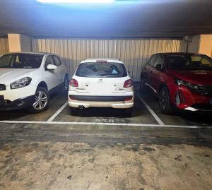 three cars parked in a parking lot in a garage at Dúplex San Lorenzo in Seville