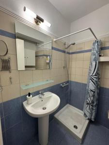 a bathroom with a sink and a shower at Siviri Holiday Home in Siviri +12 photos