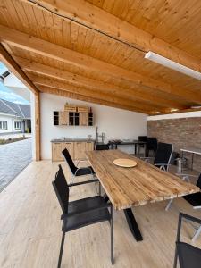 a dining room with a wooden table and chairs at Chalupa Jaroslavice in Jaroslavice