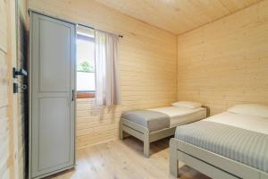 Postel nebo postele na pokoji v ubytování O.W. Laguna